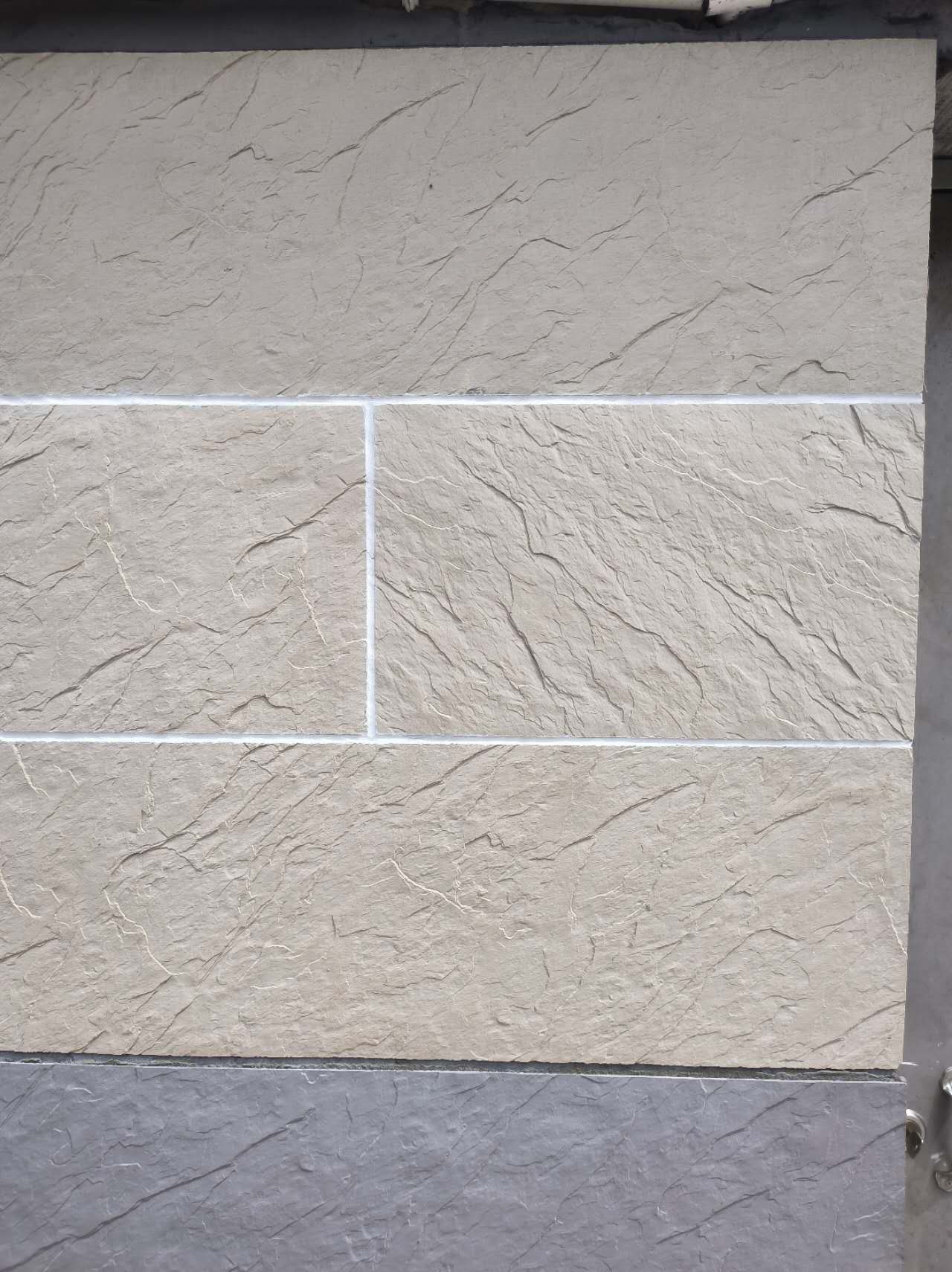 Flexible stone veneer installed on an exterior wall in a coastal environment