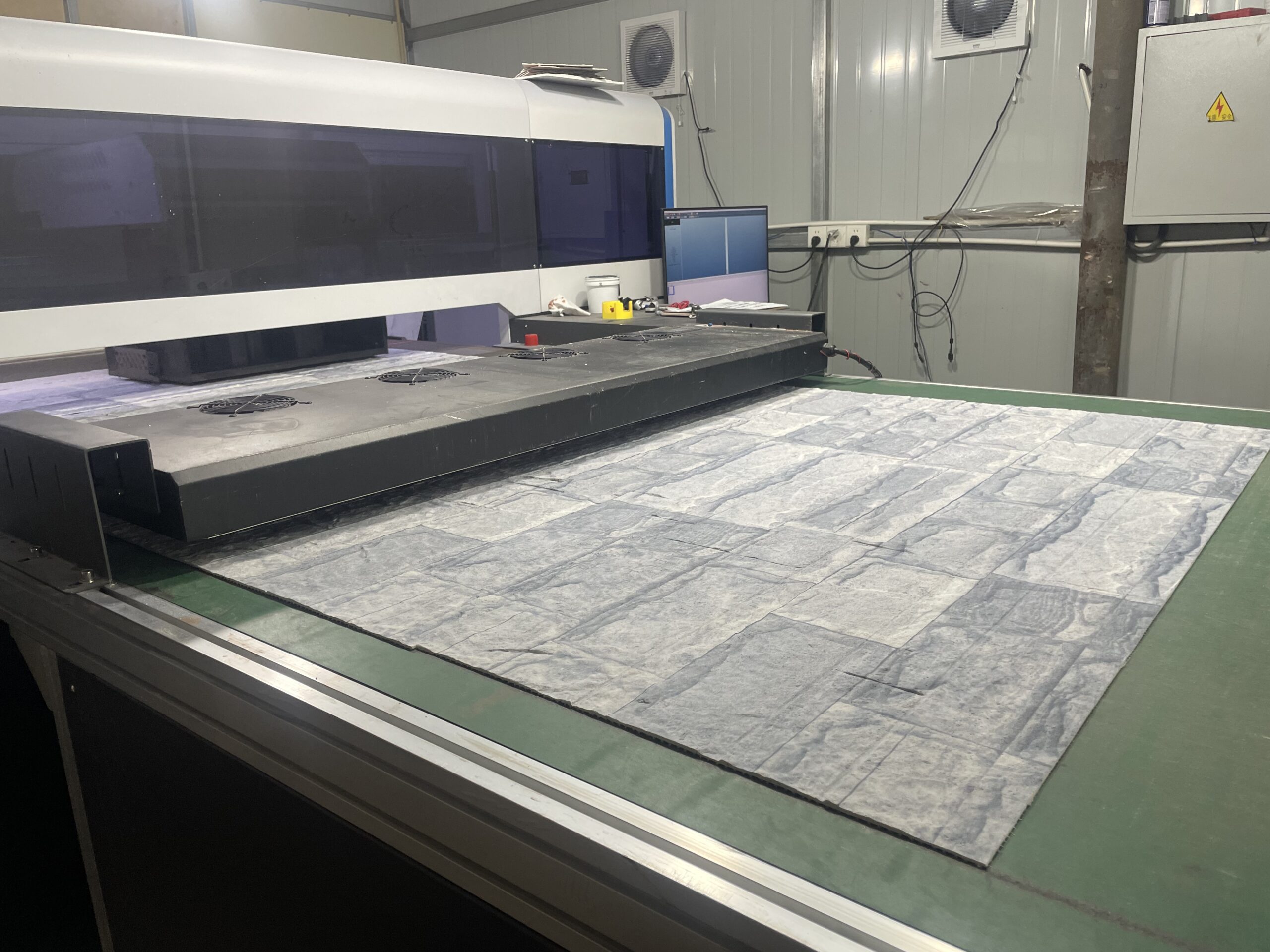 UV 3D printing machine printing a custom stone pattern onto a flexible stone panel
