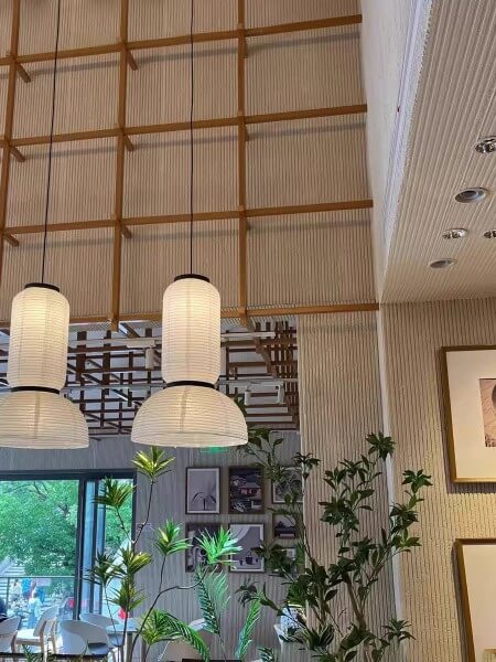 Restaurant interior with timber and stone wall cladding and pendant lighting