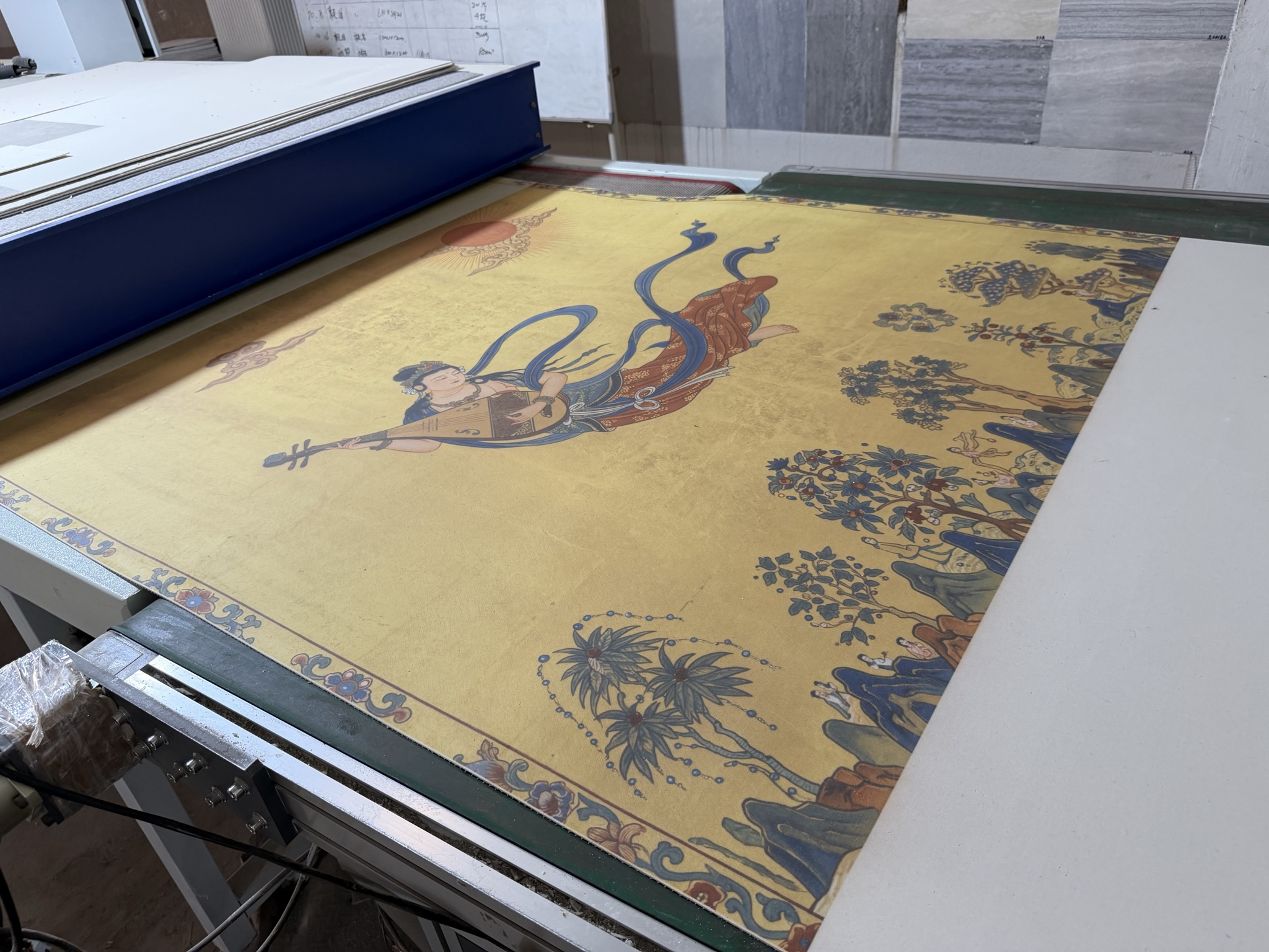Custom artwork being 3D printed onto a large flexible stone wall panel in the JMS Decor factory