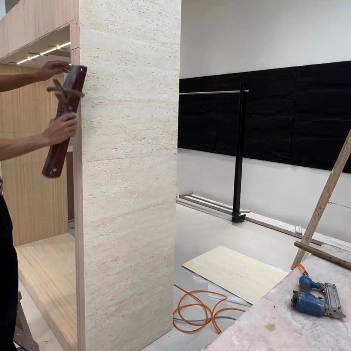 Applying flexible stone veneer to a curved surface during the JMSDECOR furniture OEM production process